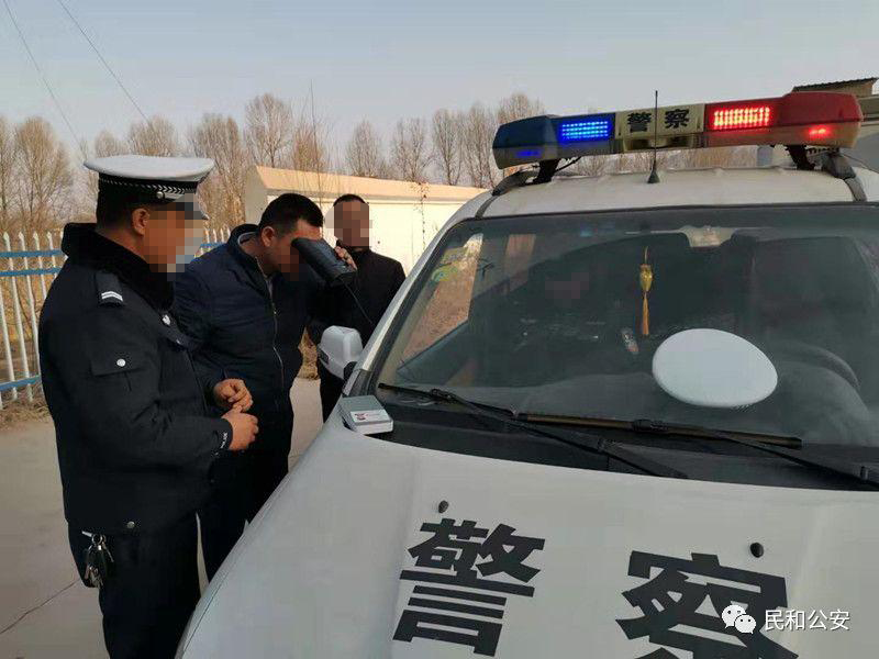 Police collect iris scans next to a police vehicle. 